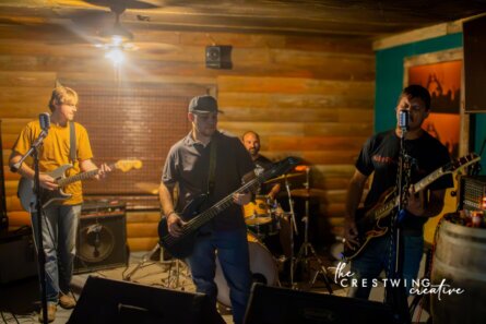 Stateline Shakes Band playing live on a dark stage with bright lights